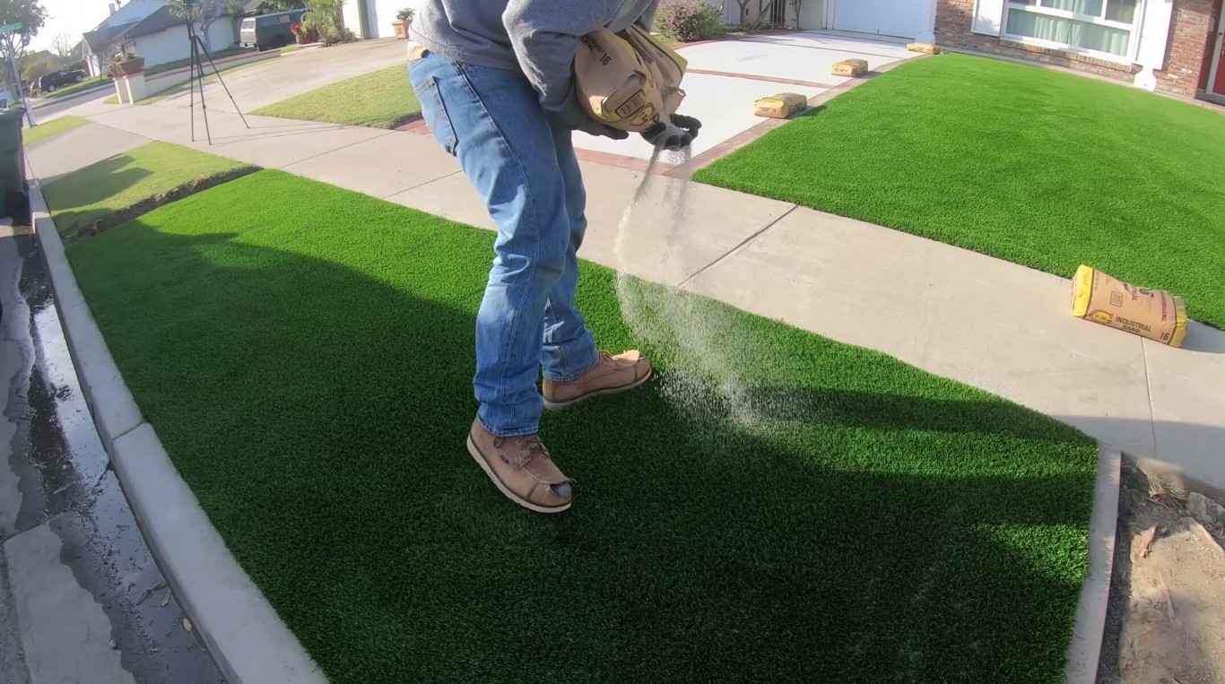 Homeowner maintaining artificial grass lawn in High Point, NC